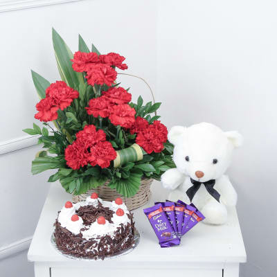 15 Red Carnations & Half Kg Black Forest Cake with Teddy & Chocolate Bars